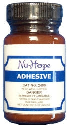 What is the best way to clean skin after using Nu-Hope 2400 adhesive?